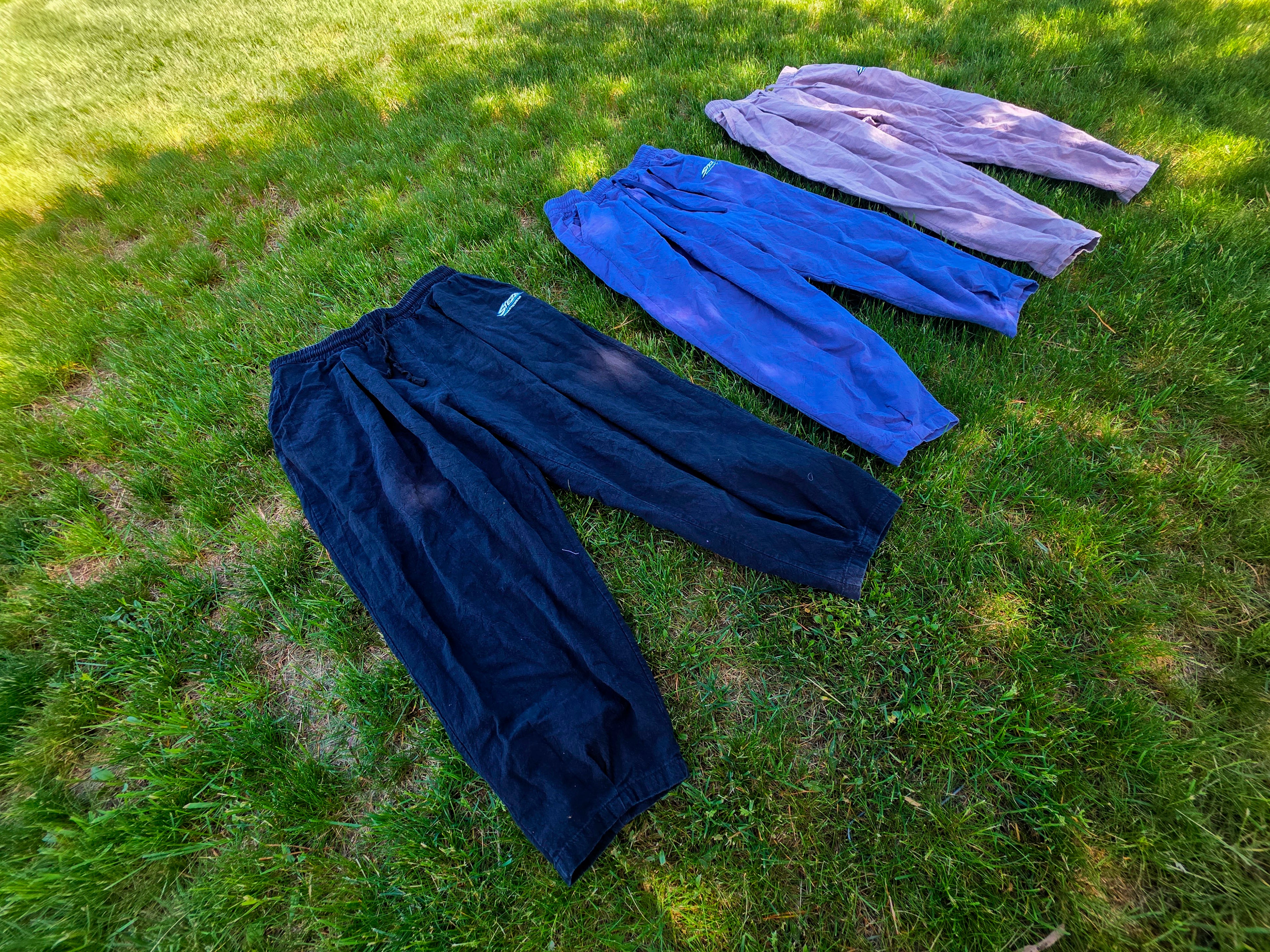STEZE all three colorways laid out on grass, lifestyle shot