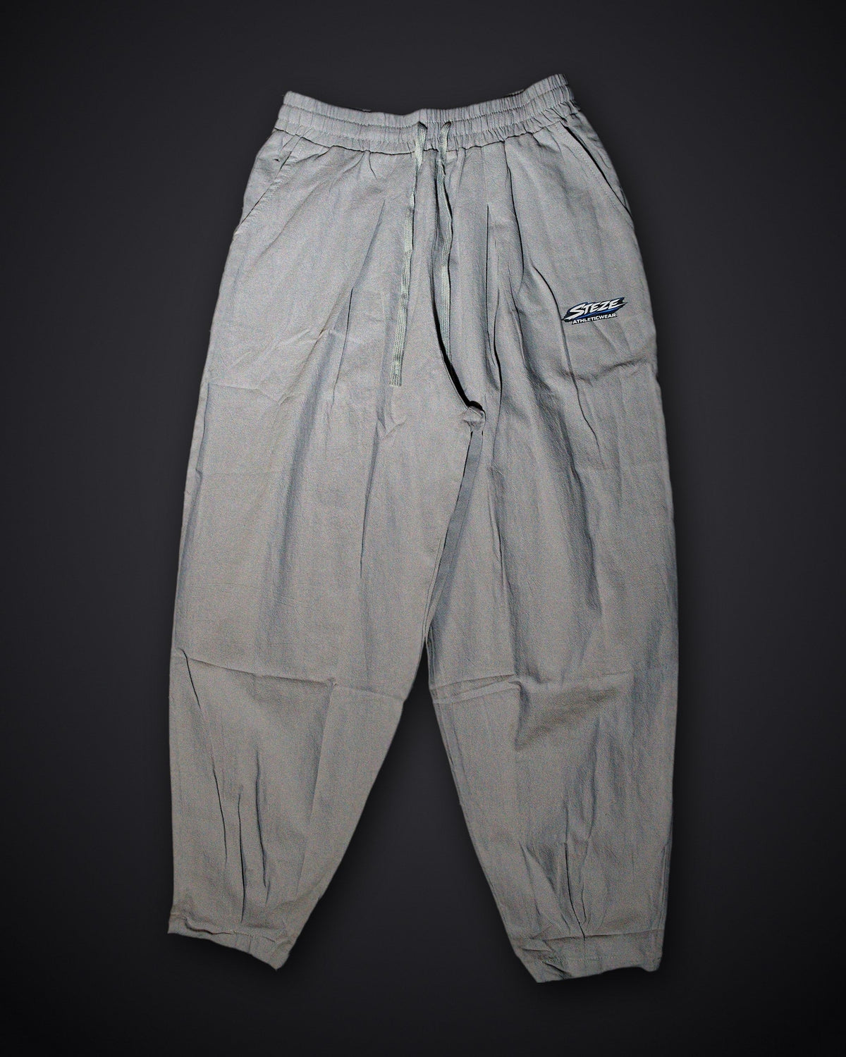 STEZE Linen Pant in gray, flat lay on dark studio background