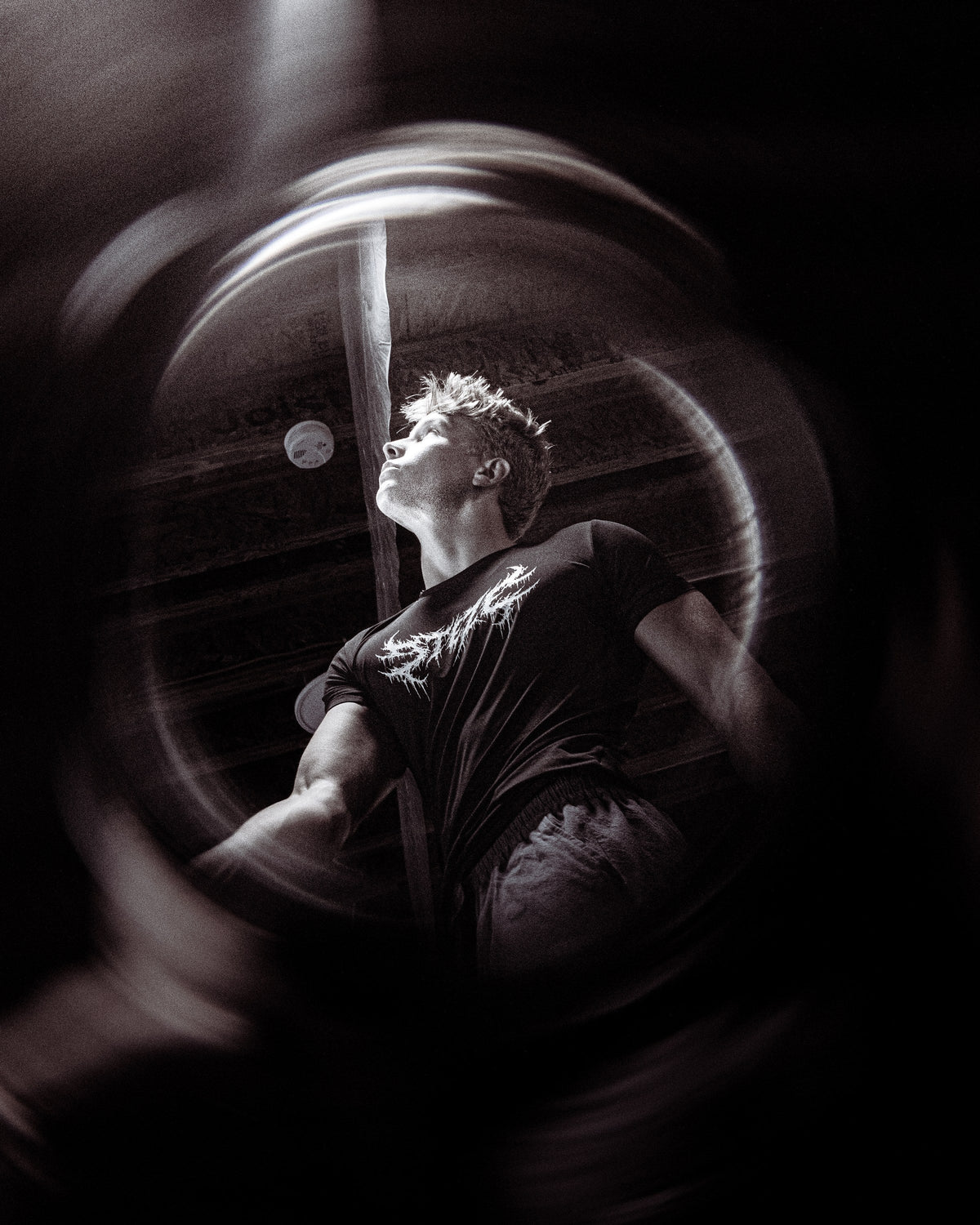 Athlete wearing a STEZE shirt, black and white light-trail portrait